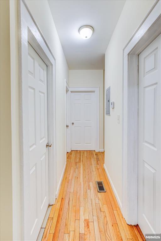 hallway with light hardwood / wood-style floors