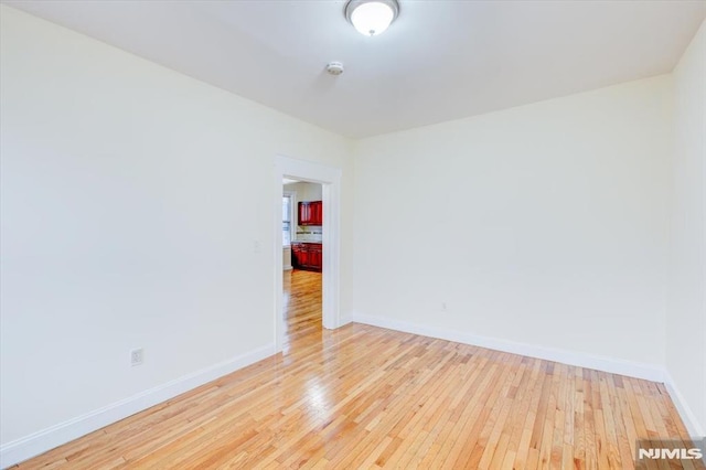 empty room with light hardwood / wood-style floors