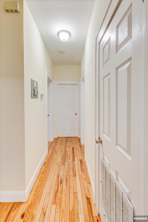 corridor with light wood-type flooring