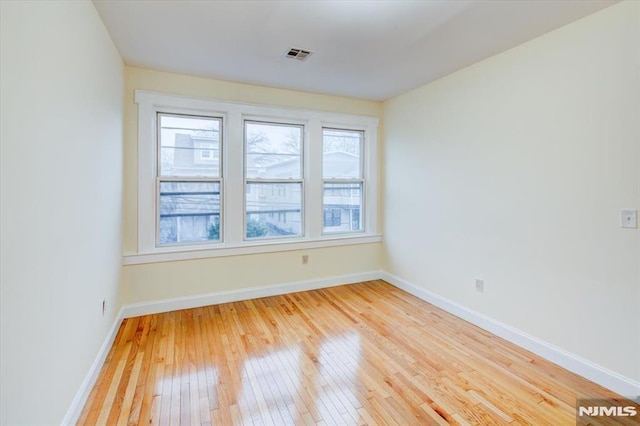 unfurnished room with wood-type flooring