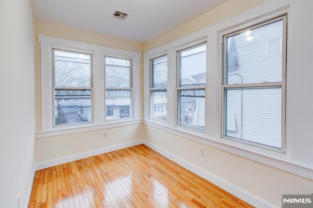 unfurnished sunroom featuring a healthy amount of sunlight