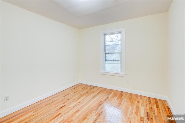 unfurnished room with light hardwood / wood-style flooring