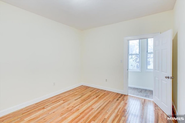 spare room with light hardwood / wood-style floors