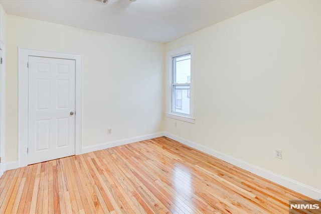 empty room with light hardwood / wood-style flooring