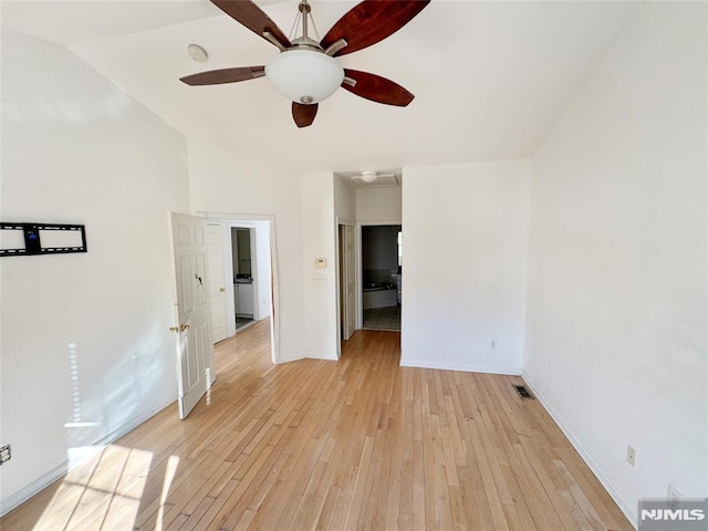 spare room with ceiling fan, light hardwood / wood-style flooring, and lofted ceiling