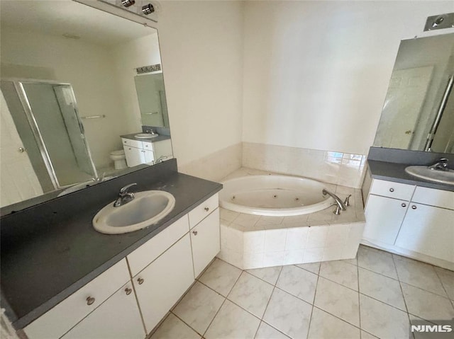 full bathroom with tile patterned flooring, shower with separate bathtub, vanity, and toilet