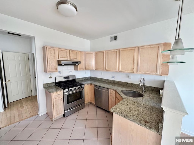 kitchen featuring light brown cabinets, light tile patterned floors, sink, and appliances with stainless steel finishes