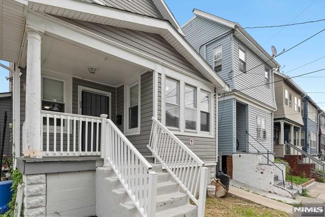 view of exterior entry featuring covered porch