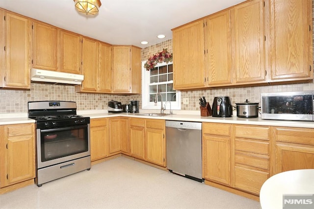 kitchen with decorative backsplash, sink, light brown cabinetry, and appliances with stainless steel finishes