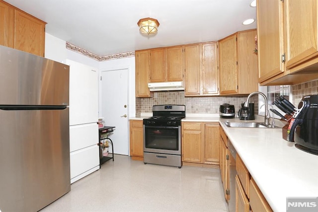 kitchen with backsplash, appliances with stainless steel finishes, sink, and light brown cabinets