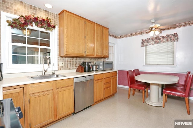 kitchen featuring ceiling fan, backsplash, sink, and stainless steel appliances