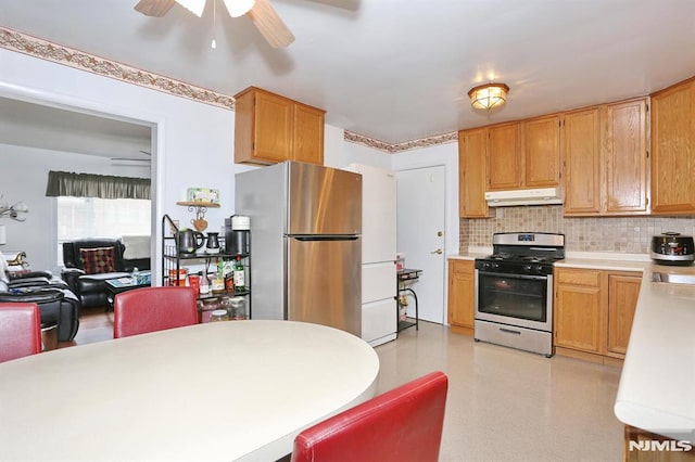 kitchen featuring decorative backsplash, appliances with stainless steel finishes, and ceiling fan