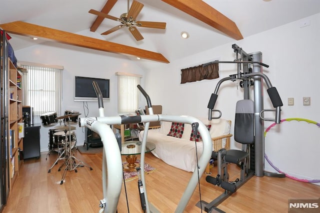 exercise area with ceiling fan, wood-type flooring, and vaulted ceiling