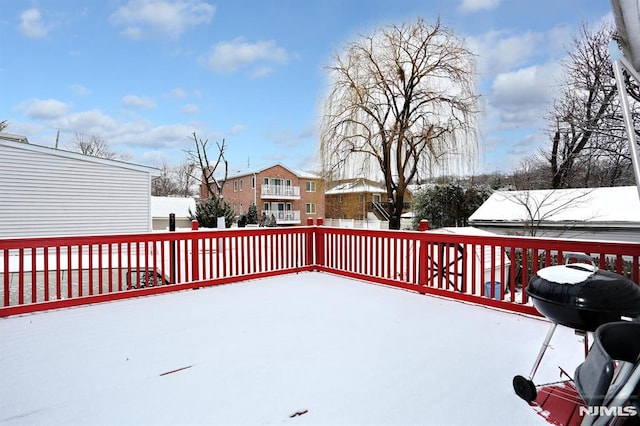 snow covered deck featuring a grill