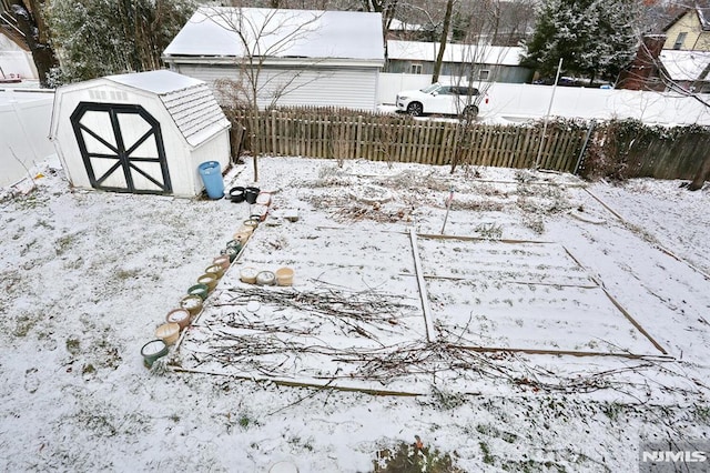 snowy yard with a storage unit