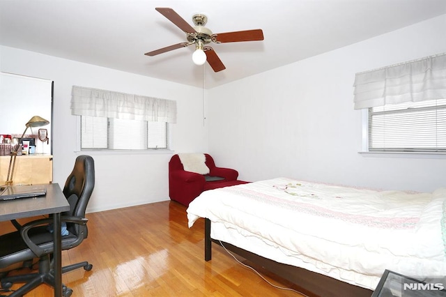 bedroom with ceiling fan and wood-type flooring