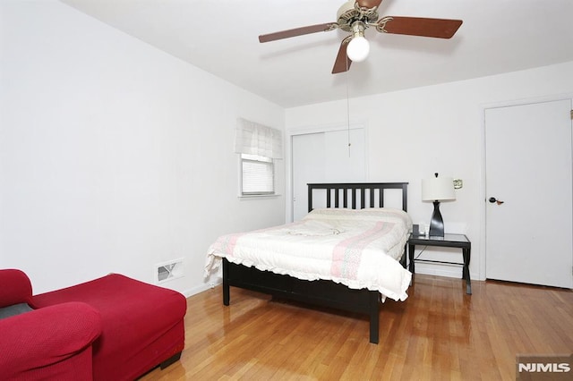 bedroom with ceiling fan and hardwood / wood-style floors