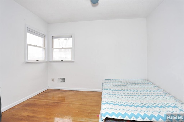 bedroom with hardwood / wood-style flooring