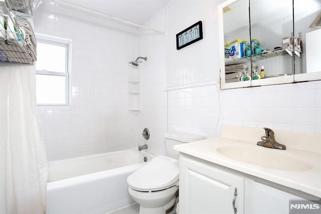 full bathroom featuring toilet, vanity, and shower / tub combo with curtain