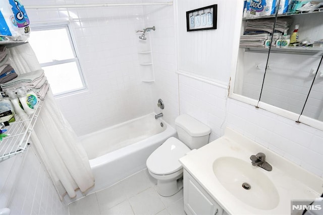 full bathroom with tile patterned floors, vanity, shower / bath combination with curtain, tile walls, and toilet