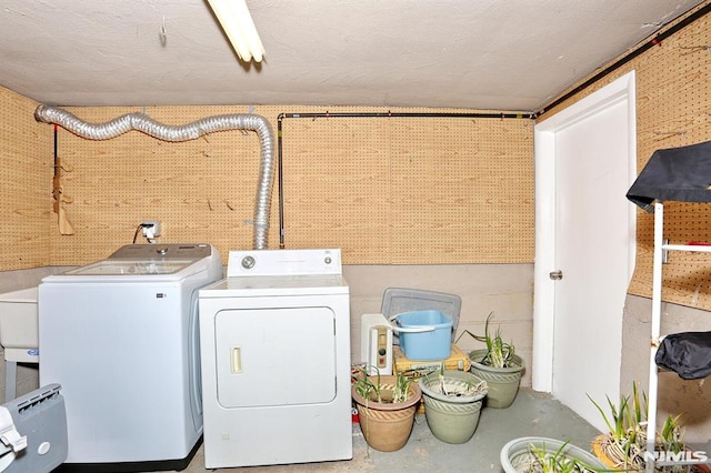 washroom with washing machine and clothes dryer