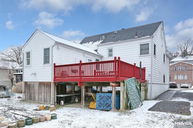 snow covered property featuring a wooden deck