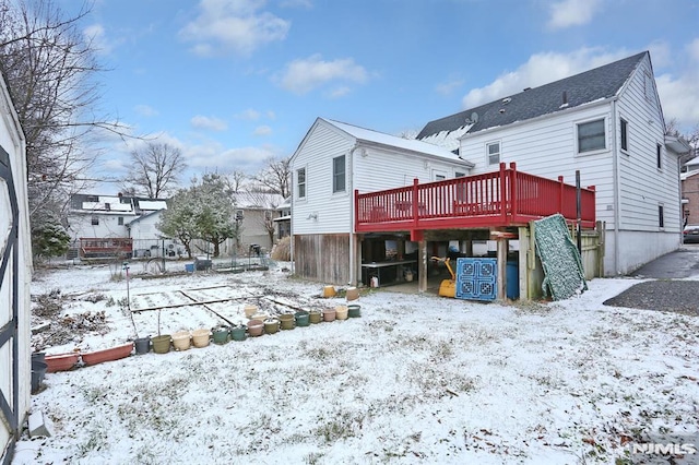 snow covered house with a deck