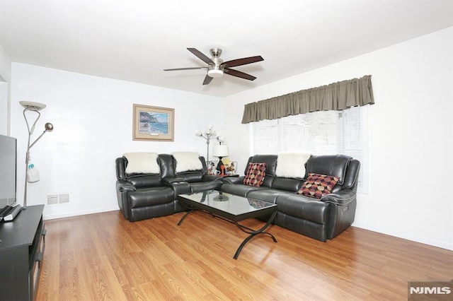 living room featuring ceiling fan and light hardwood / wood-style flooring