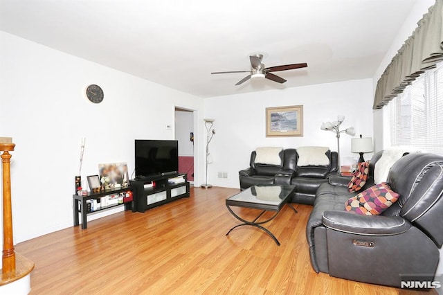 living room featuring ceiling fan and light hardwood / wood-style flooring