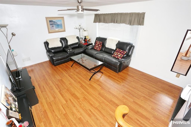 living room with ceiling fan and hardwood / wood-style flooring