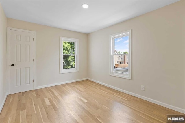 unfurnished room with light wood-type flooring