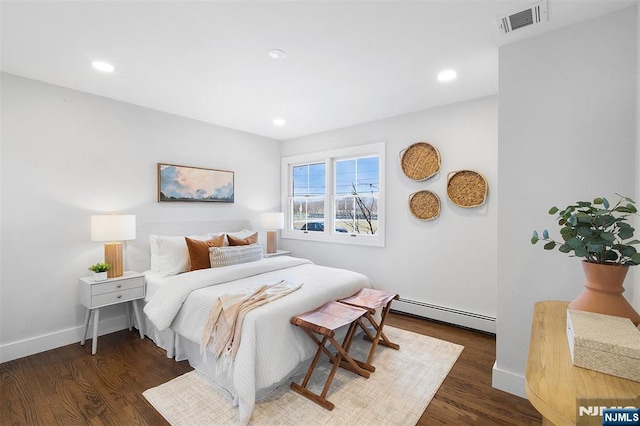 bedroom featuring dark wood-type flooring and a baseboard radiator