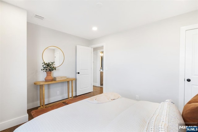 bedroom with hardwood / wood-style flooring