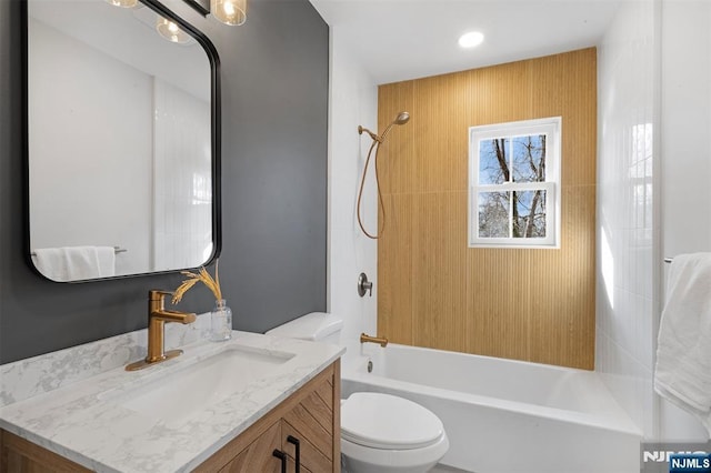 full bathroom with tiled shower / bath combo, vanity, and toilet