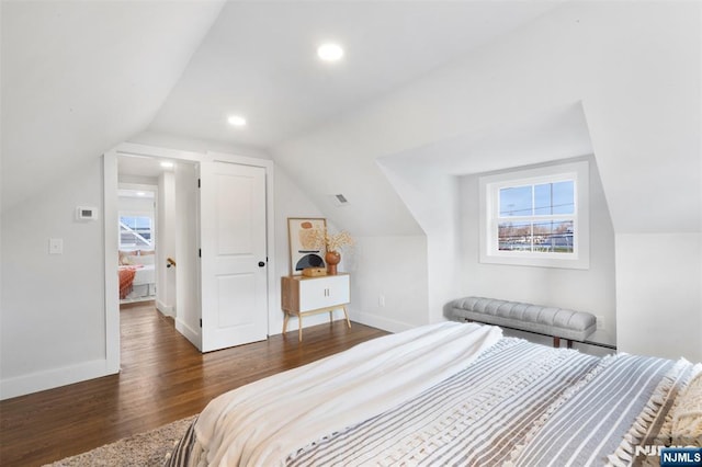 bedroom with lofted ceiling and dark hardwood / wood-style floors