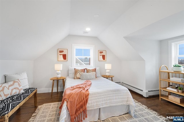 bedroom featuring dark hardwood / wood-style flooring, a baseboard radiator, and lofted ceiling