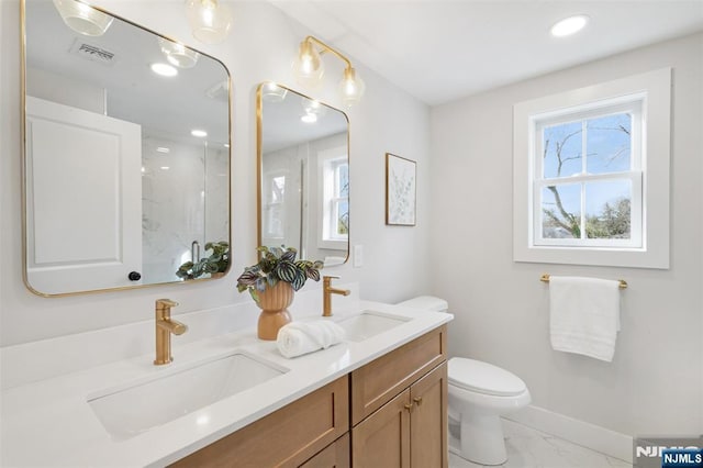 bathroom with vanity, toilet, and walk in shower