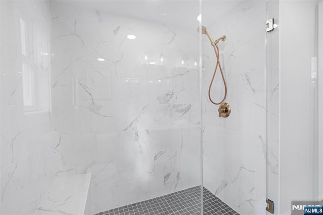 bathroom with a tile shower