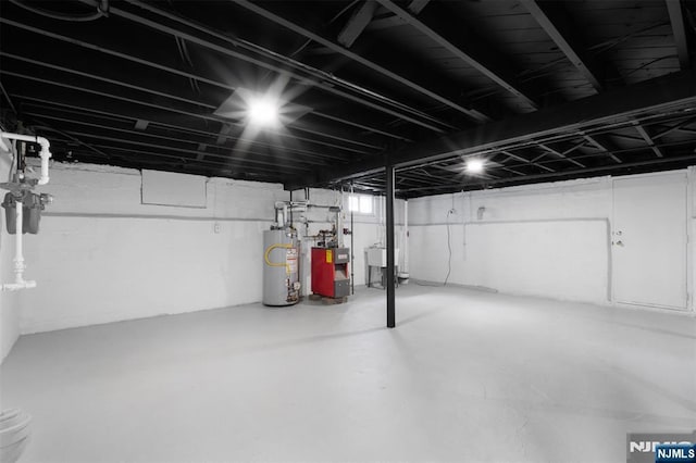 basement featuring sink and gas water heater