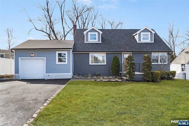 cape cod home featuring a garage and a front lawn