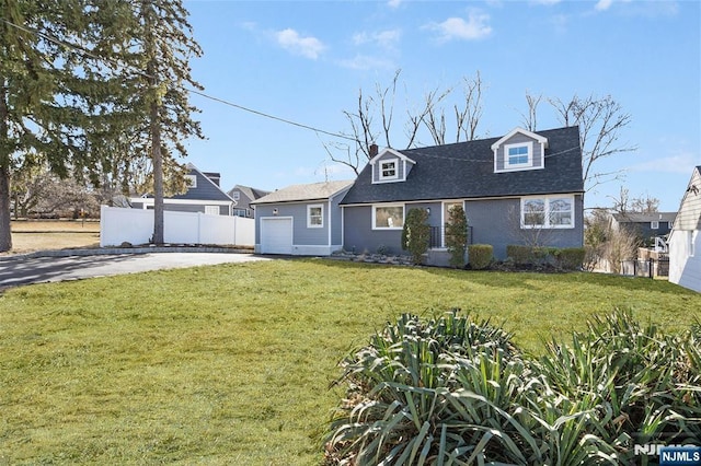 new england style home with a garage and a front lawn