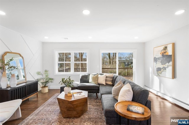 living room featuring dark wood-type flooring and baseboard heating