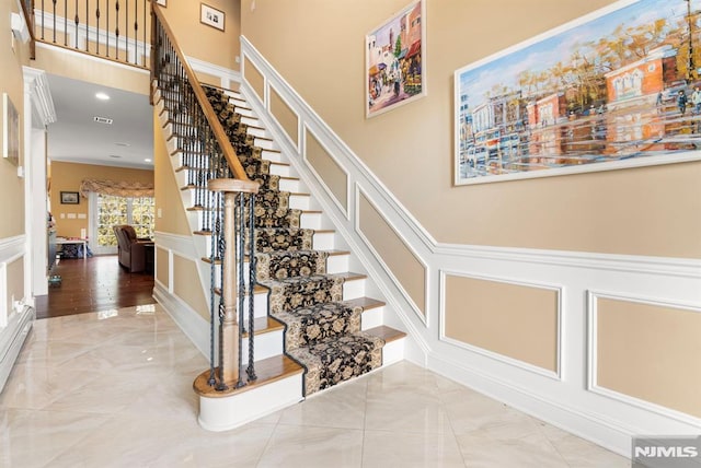 stairs featuring a towering ceiling