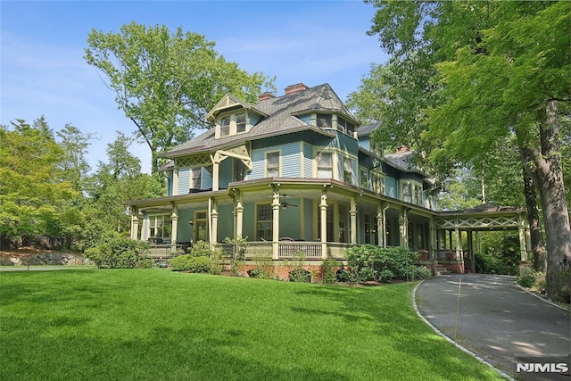 exterior space with a lawn and covered porch