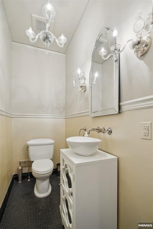 bathroom with tile patterned floors, vanity, and toilet