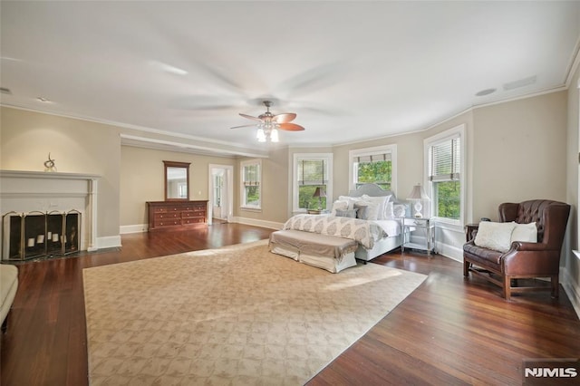 bedroom featuring ceiling fan, dark hardwood / wood-style flooring, and ornamental molding