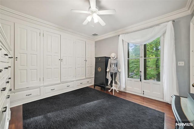 workout room featuring ceiling fan, dark hardwood / wood-style floors, and crown molding