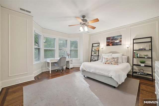 bedroom with ceiling fan and dark wood-type flooring