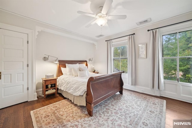 bedroom with ceiling fan and dark wood-type flooring