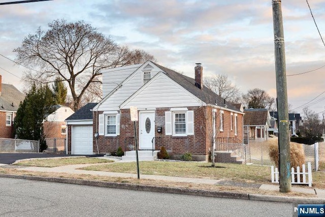 bungalow with a yard and a garage